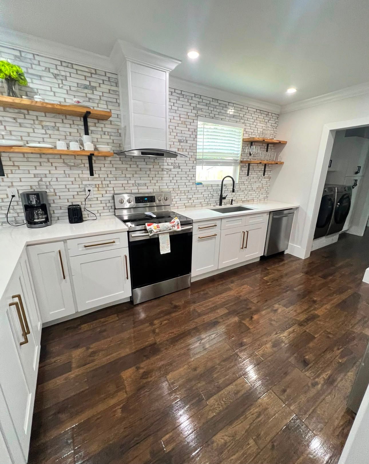 Sparkling clean kitchen with white cabinets and subway tile backsplash